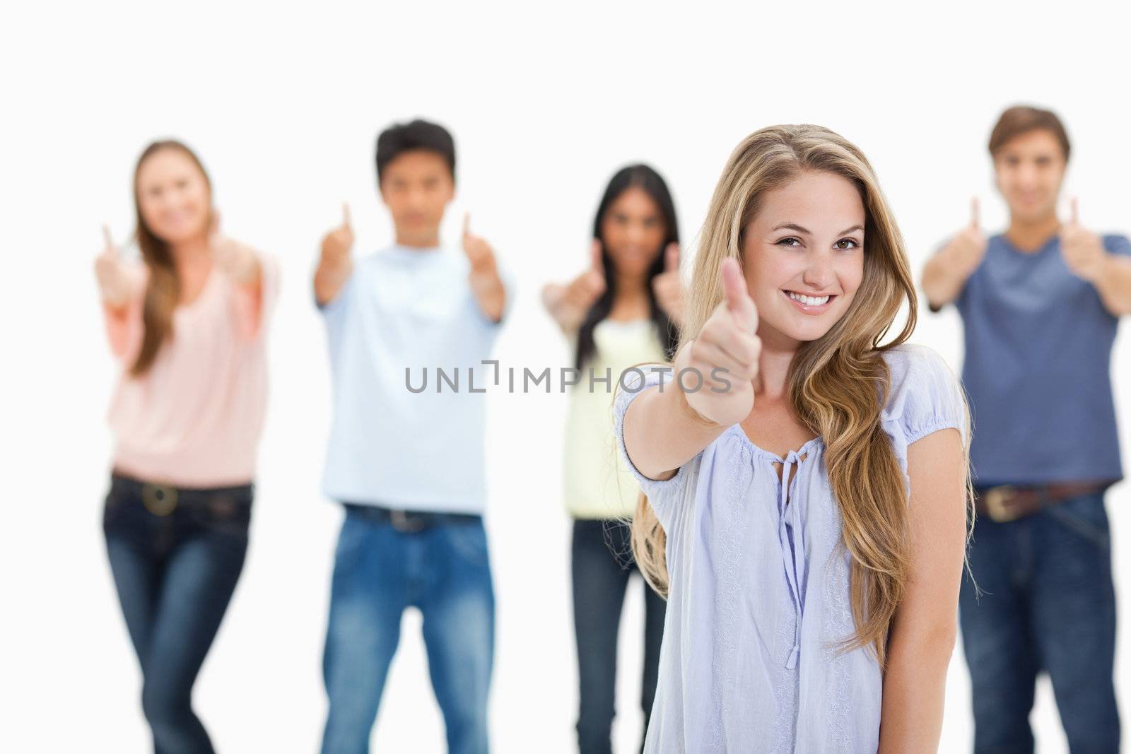 Close-up of people smiling and approving with one woman in foreg by Wavebreakmedia