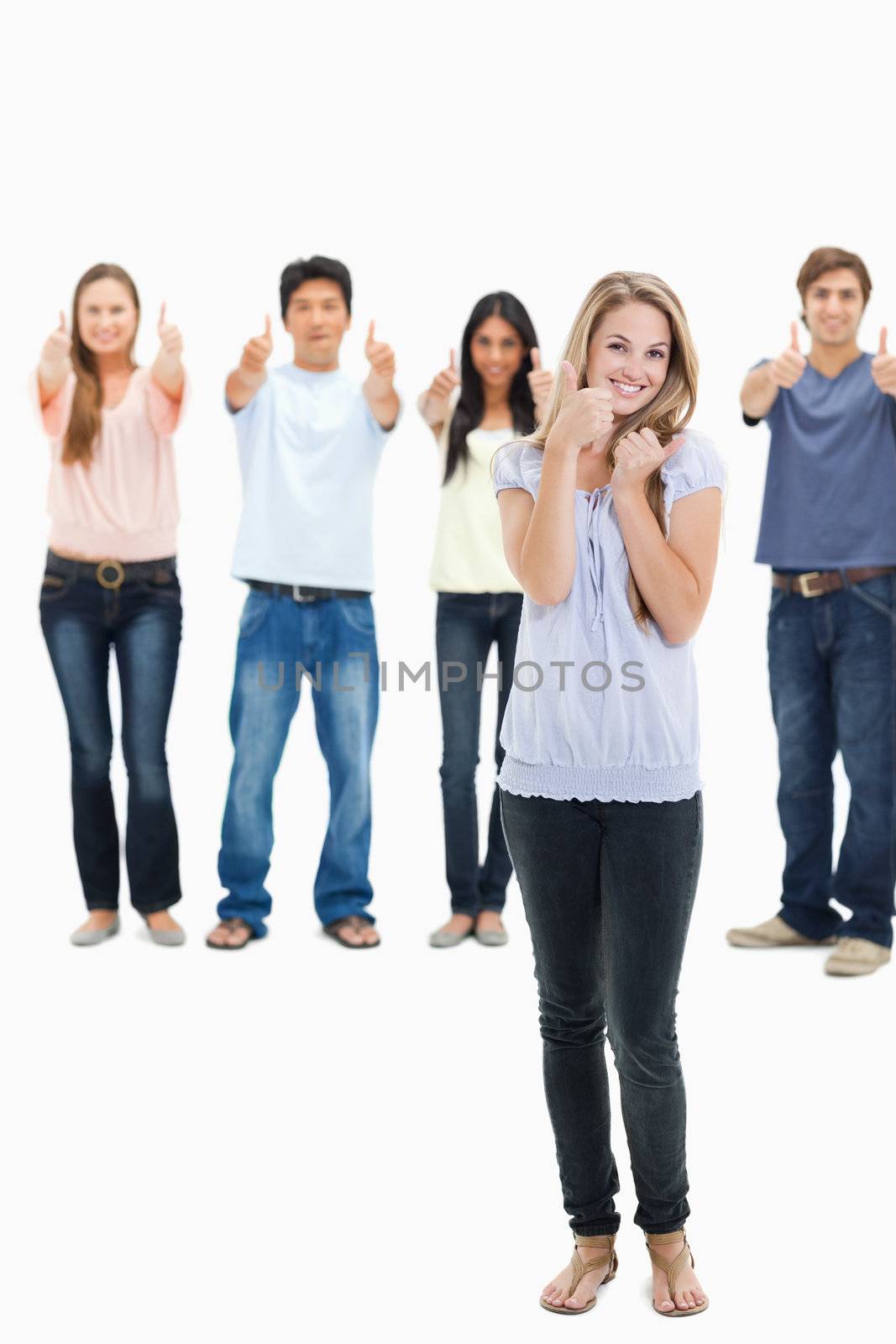 People smiling and approving with one young woman in foreground by Wavebreakmedia