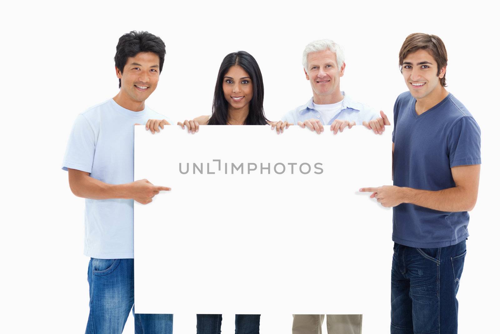 People in jeans holding and showing a big sign against white background
