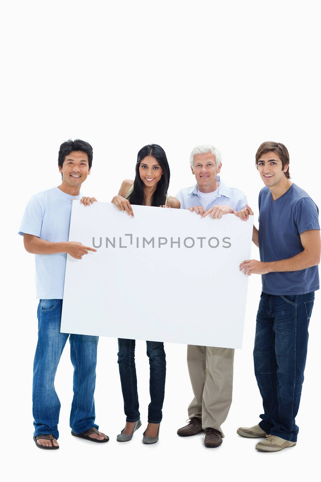 Smiling people holding and showing a big sign against white background