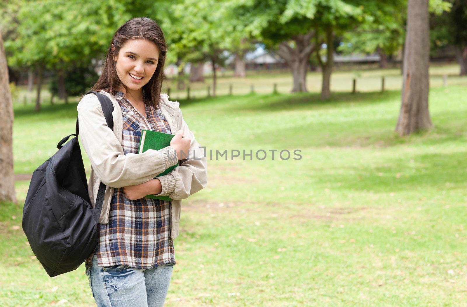 Young student holding textbook by Wavebreakmedia
