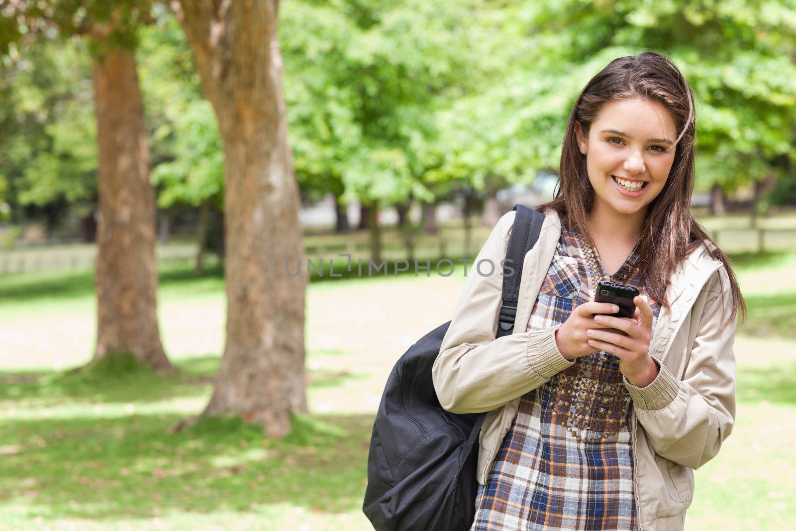 Portrait of a young student using a smartphone by Wavebreakmedia