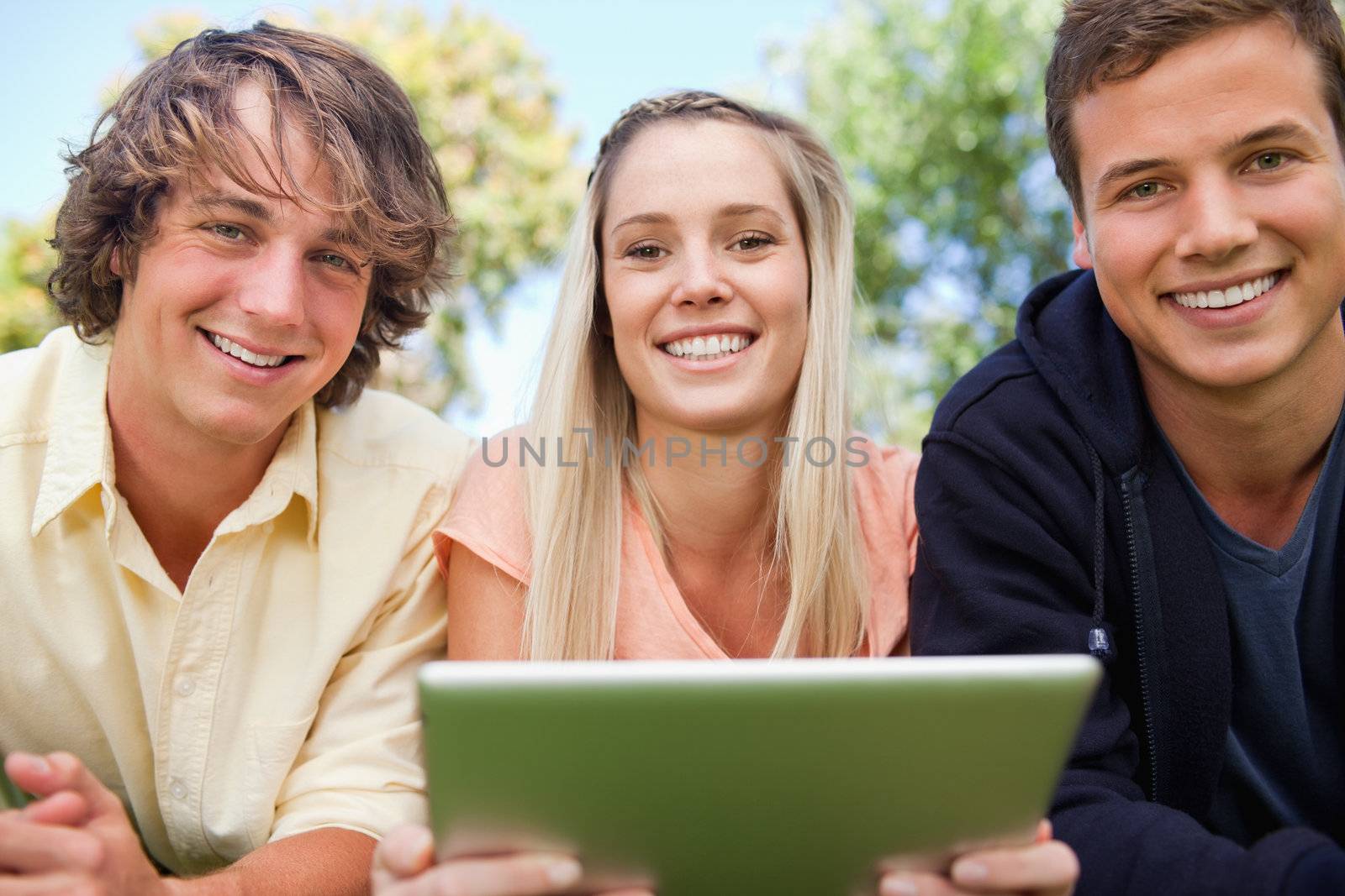 Portrait of three students using a tactile tablet by Wavebreakmedia