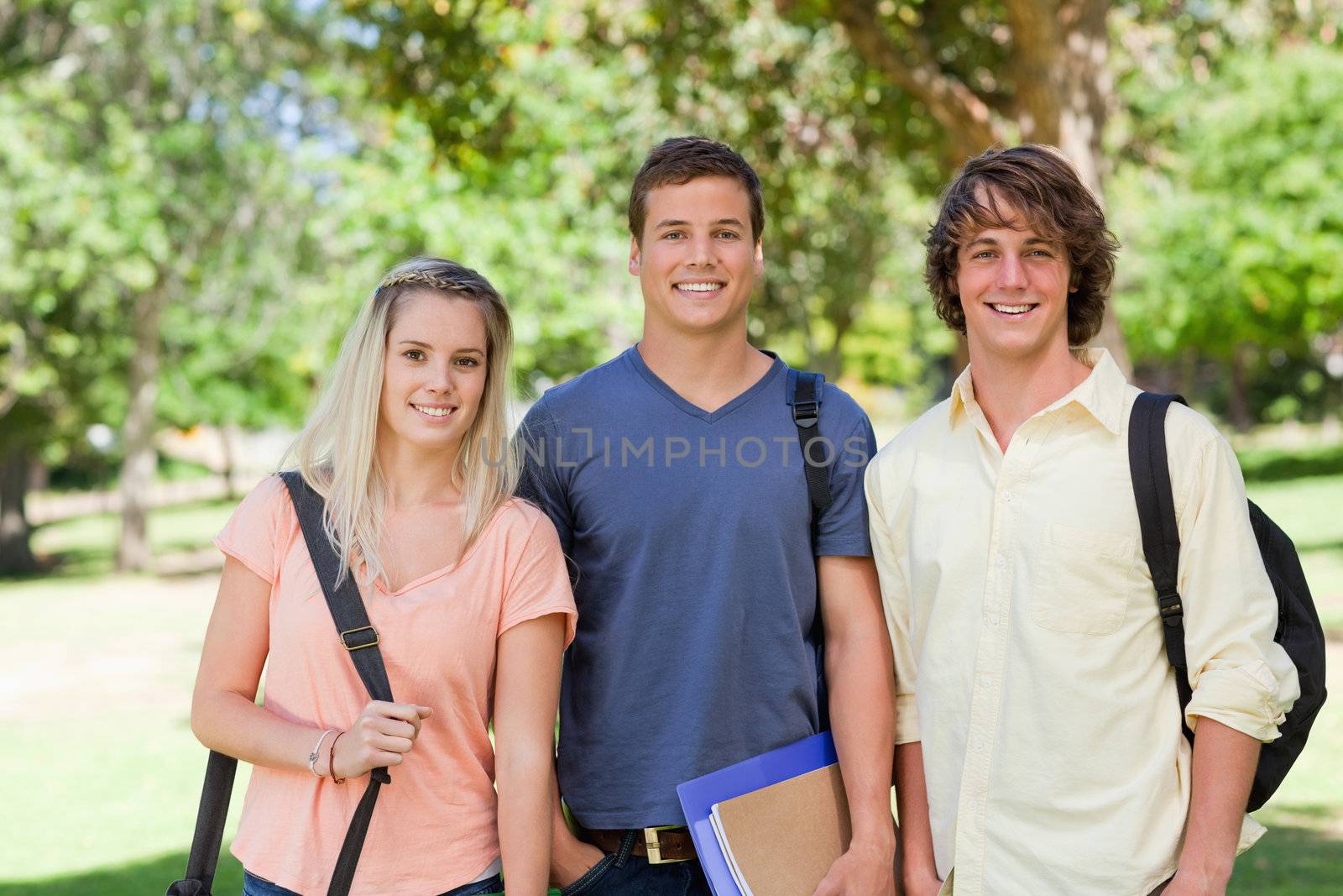 Portrait of Three students side by side in a park