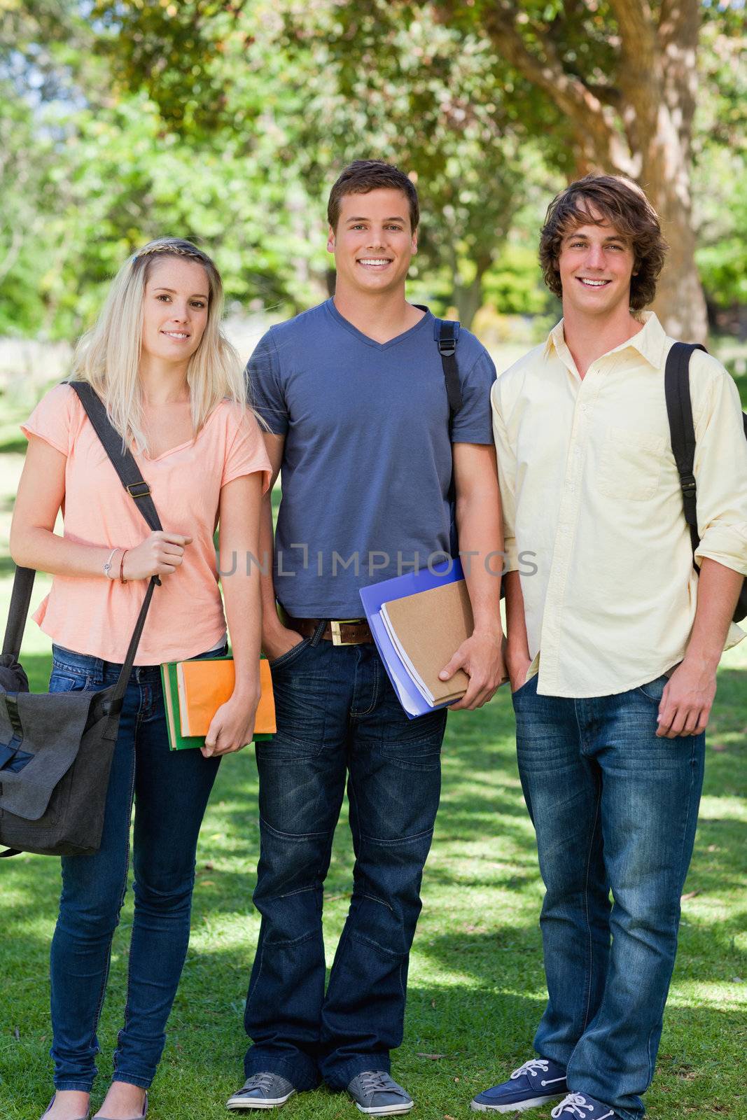 Three students posing side by side  by Wavebreakmedia