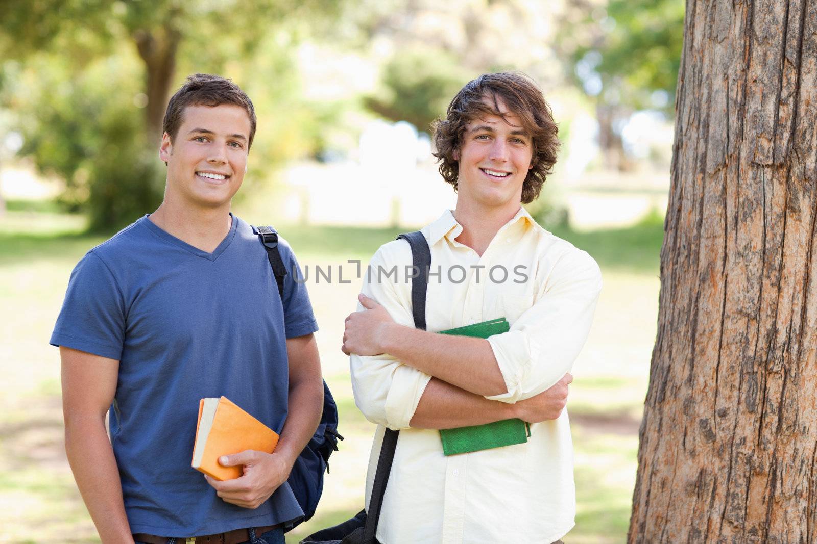 Close-up of two standing male students in a park