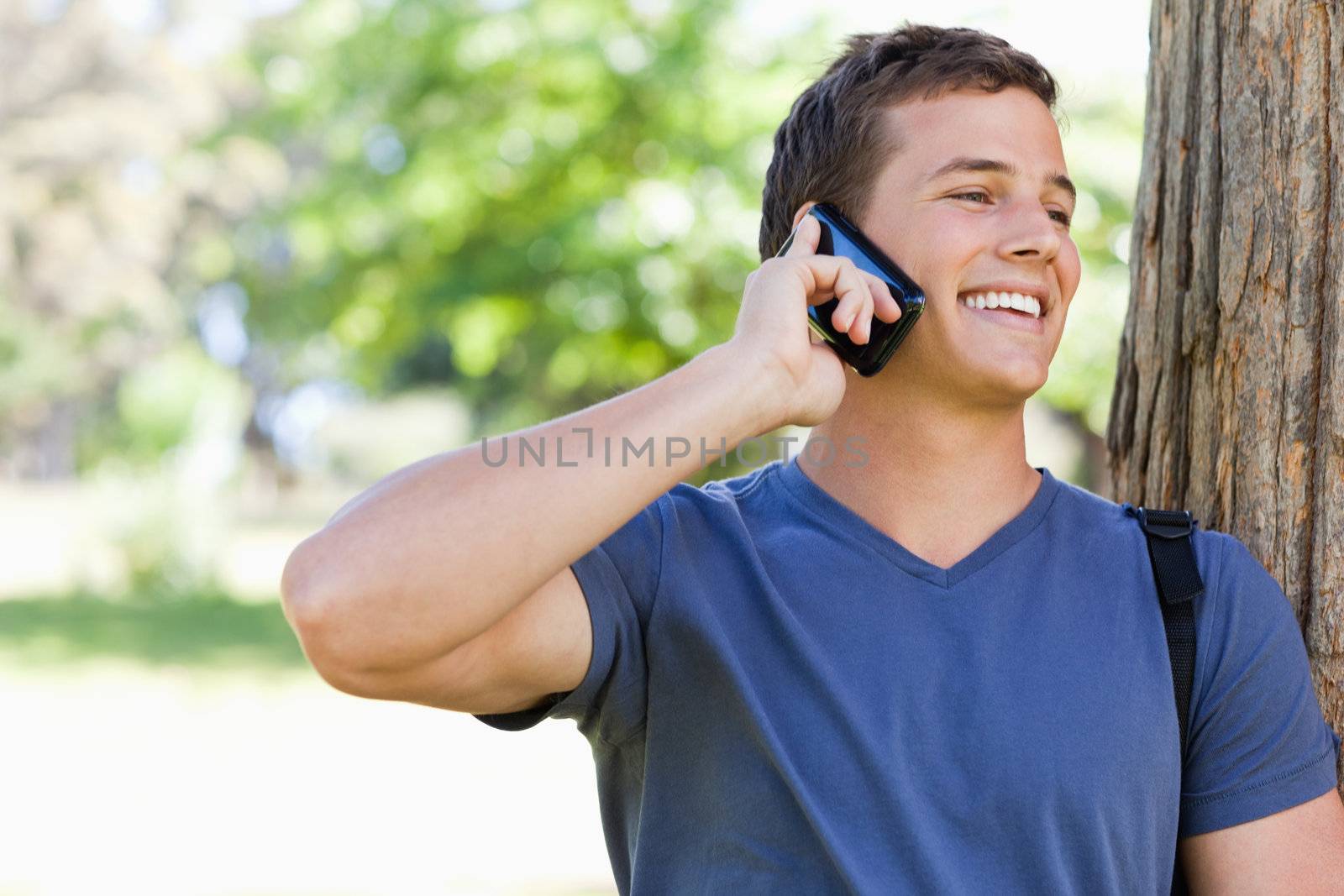 Close-up of a muscled student on the phone by Wavebreakmedia