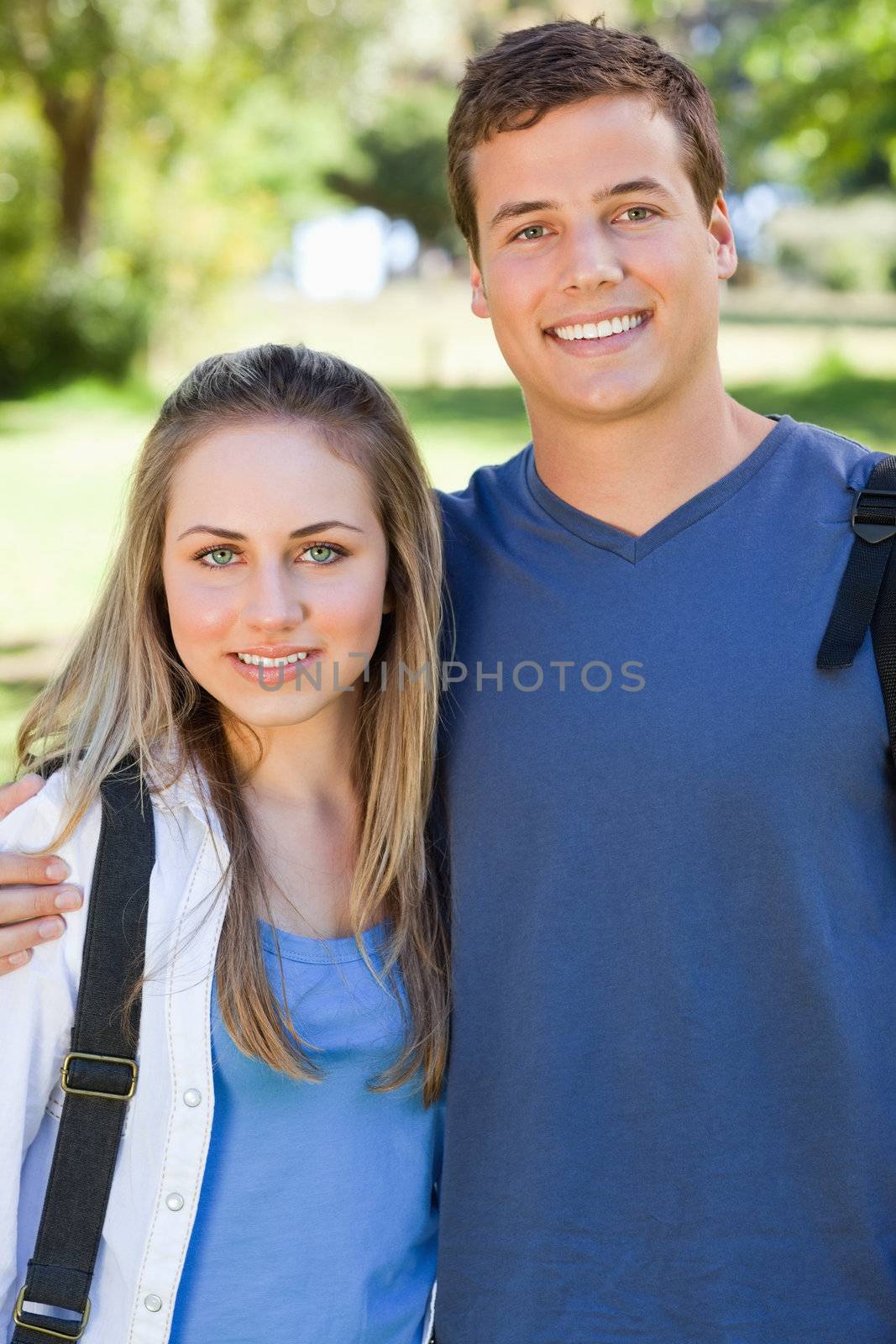 Portrait of a young couple smiling in a park