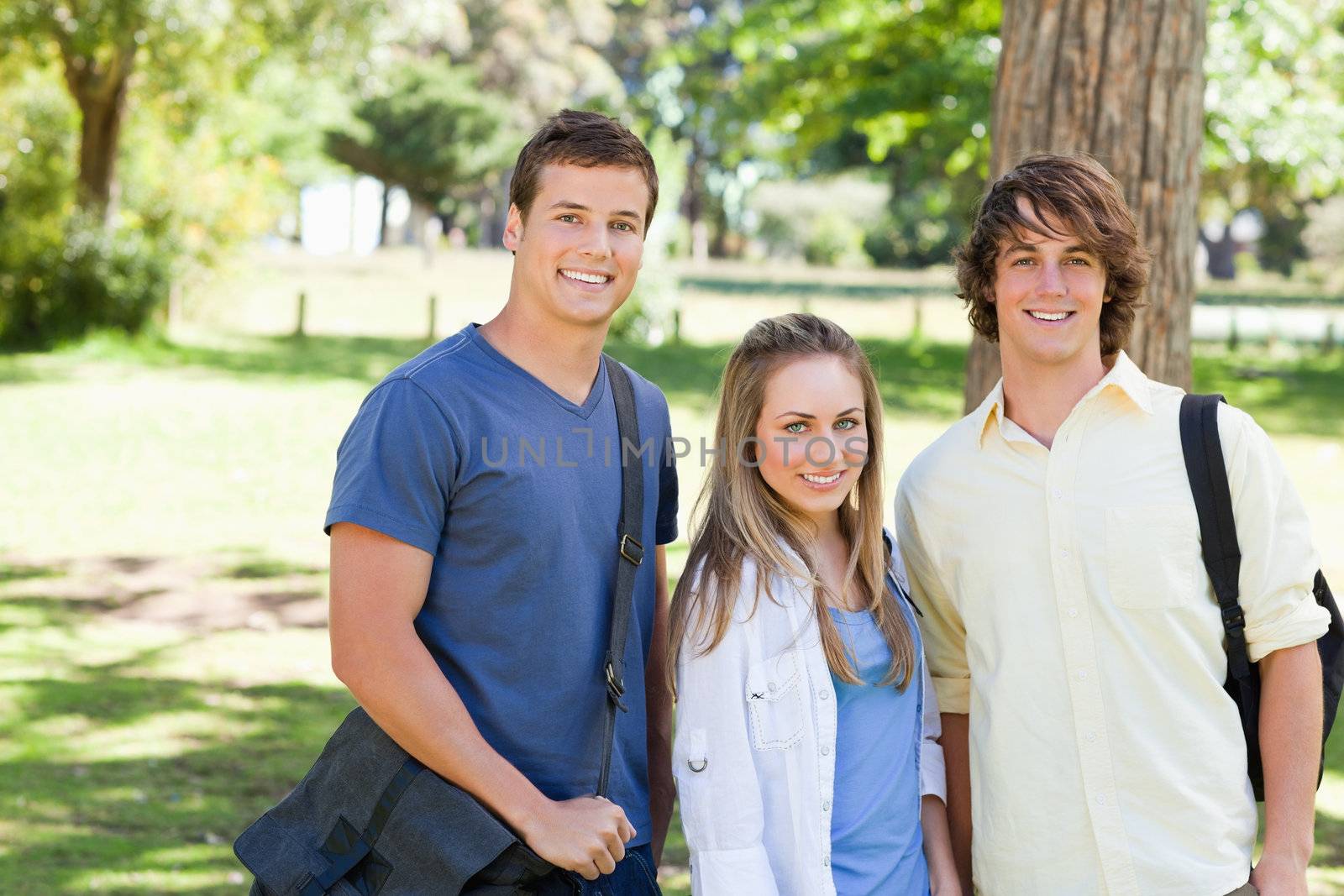 Portrait of smiling students with their bags by Wavebreakmedia