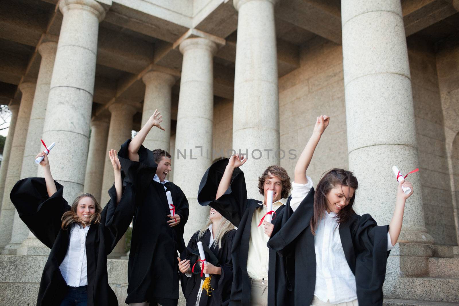 Graduates dancing in togas by Wavebreakmedia