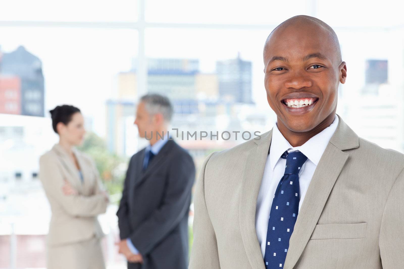 Young manager standing upright while smiling by Wavebreakmedia