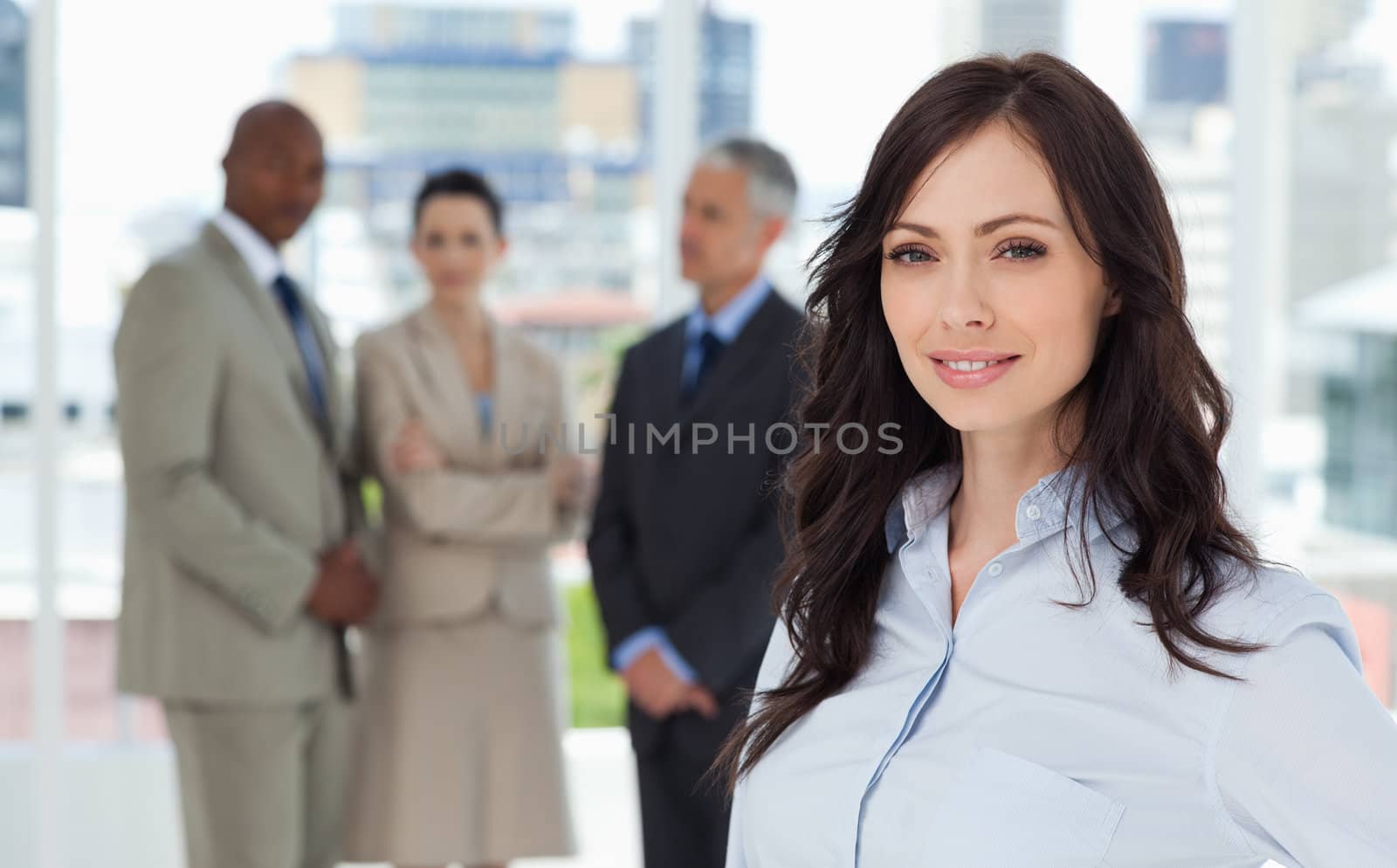 Businesswoman smiling and standing in a bright room with her tea by Wavebreakmedia