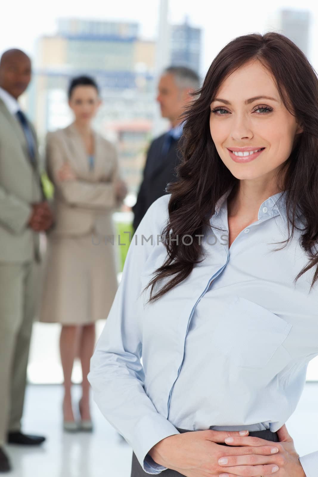 Young businesswoman standing upright with her hands crossed on h by Wavebreakmedia