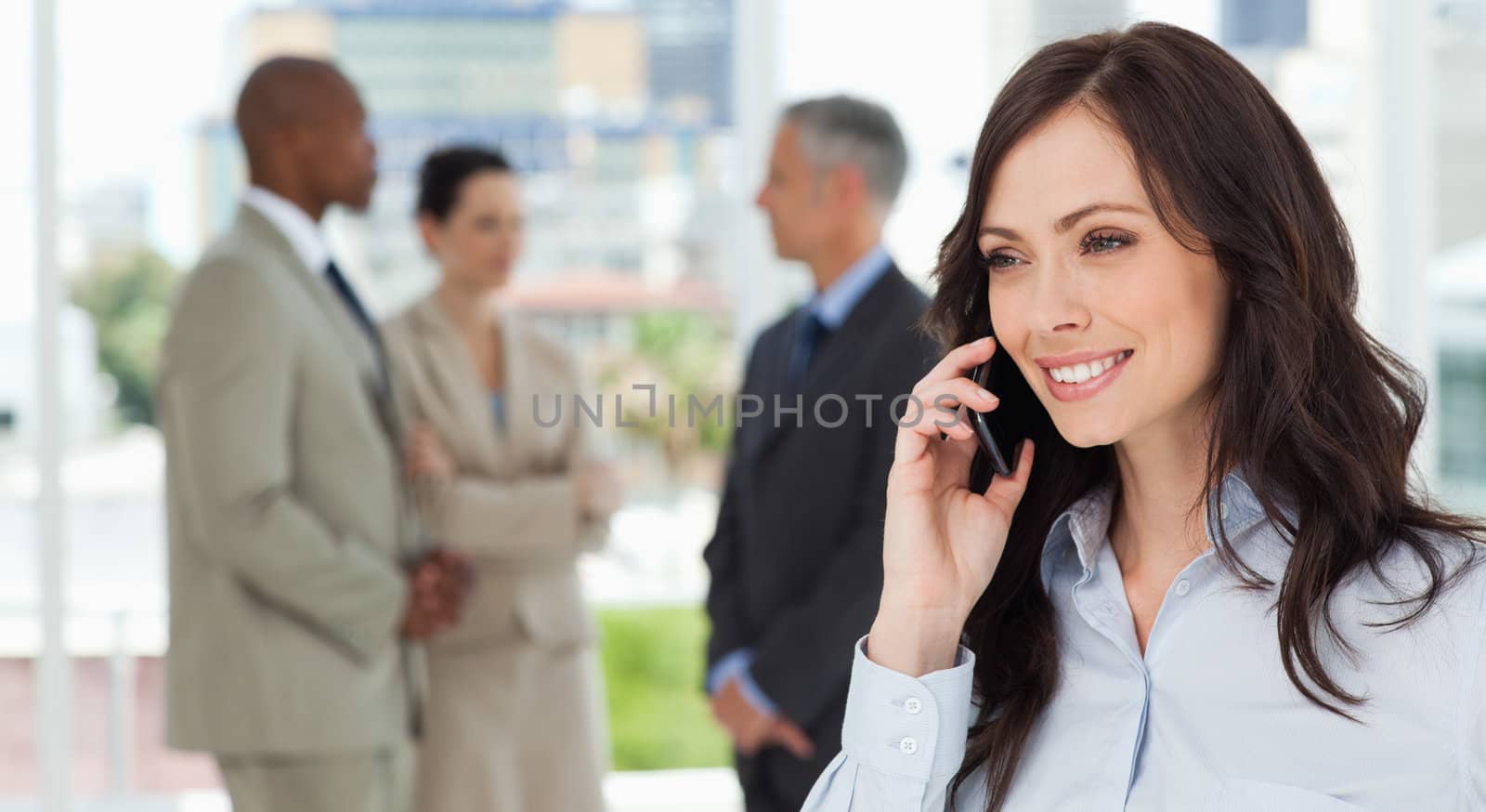 Businesswoman talking on the phone in a relaxed way with her tea by Wavebreakmedia