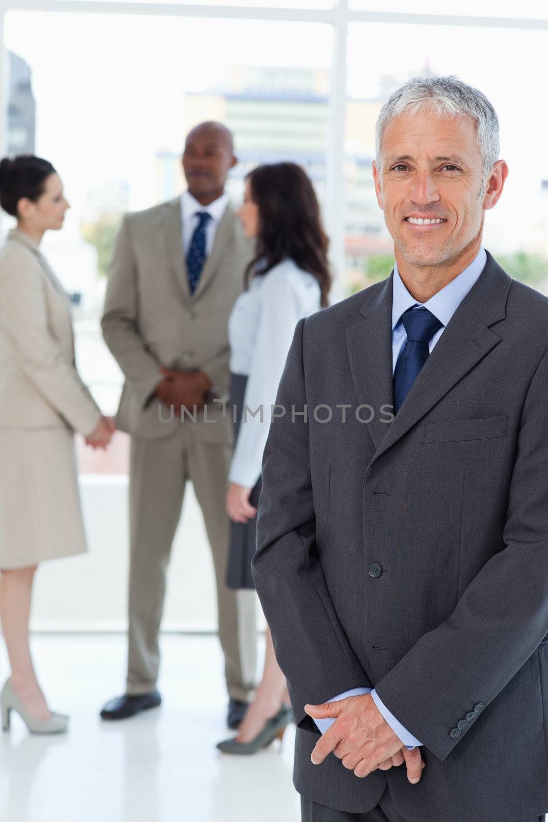 Serious manager standing upright with his hands crossed by Wavebreakmedia