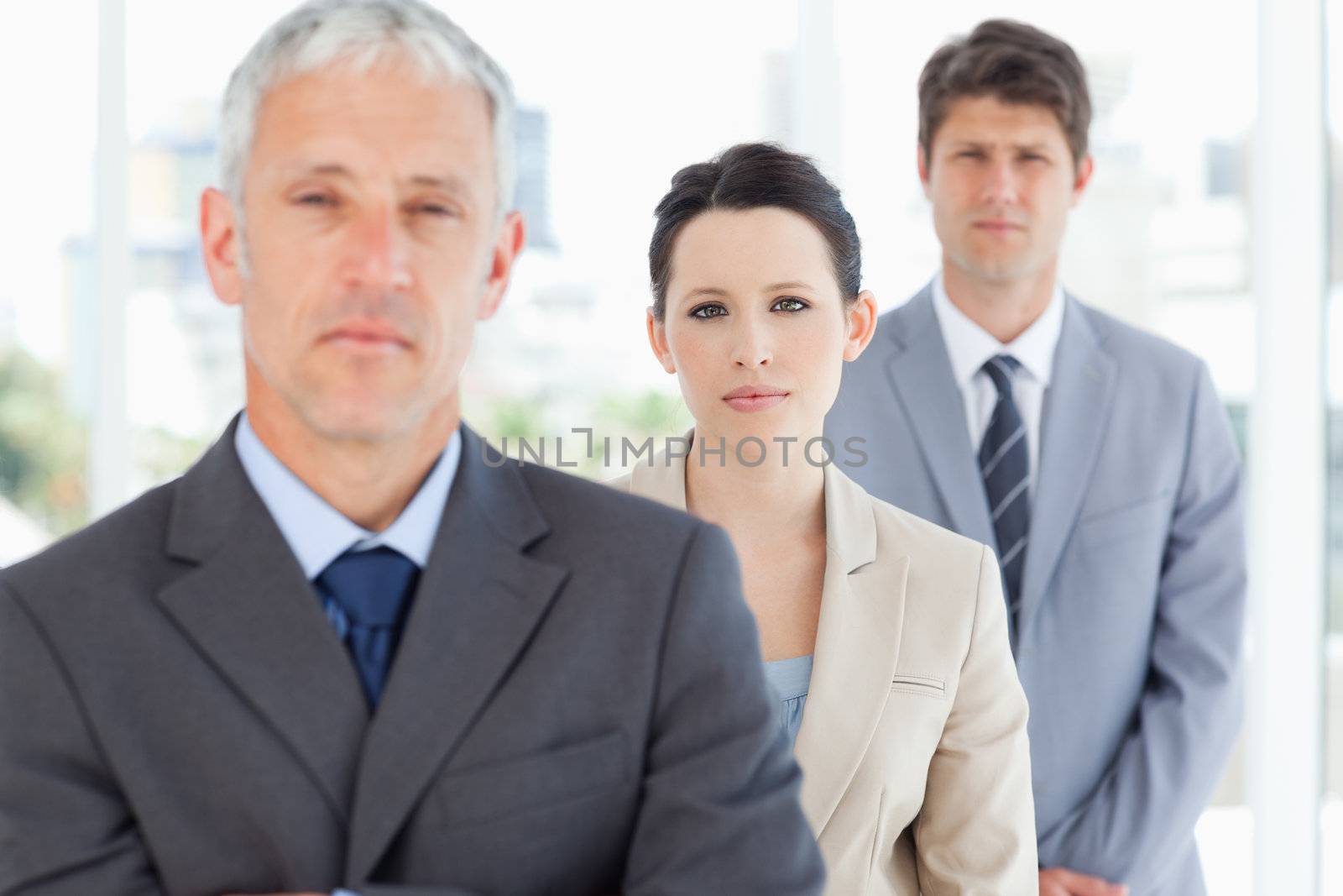 Young businesswoman accompanied by her manager and one colleague by Wavebreakmedia