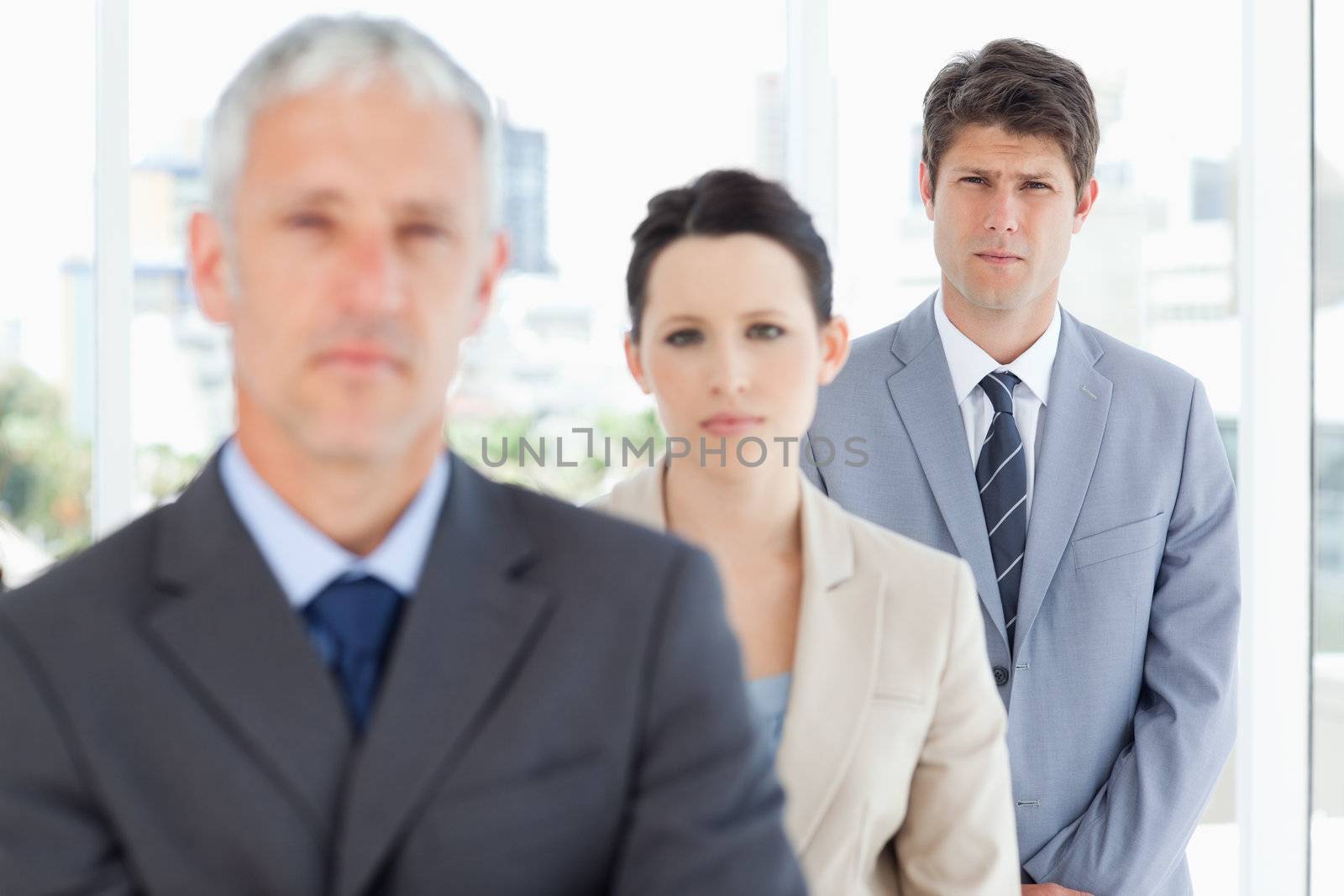 Young serious businessman following his team