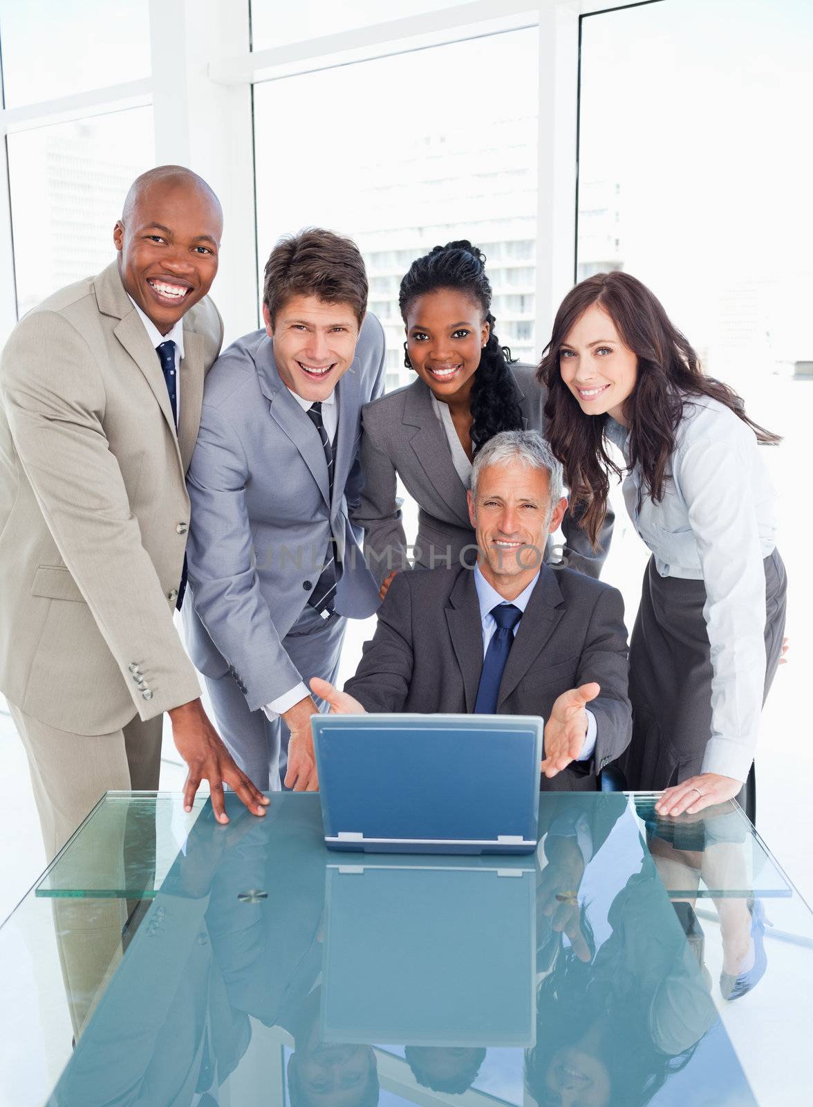 Four business people standing behind their manager proudly showi by Wavebreakmedia
