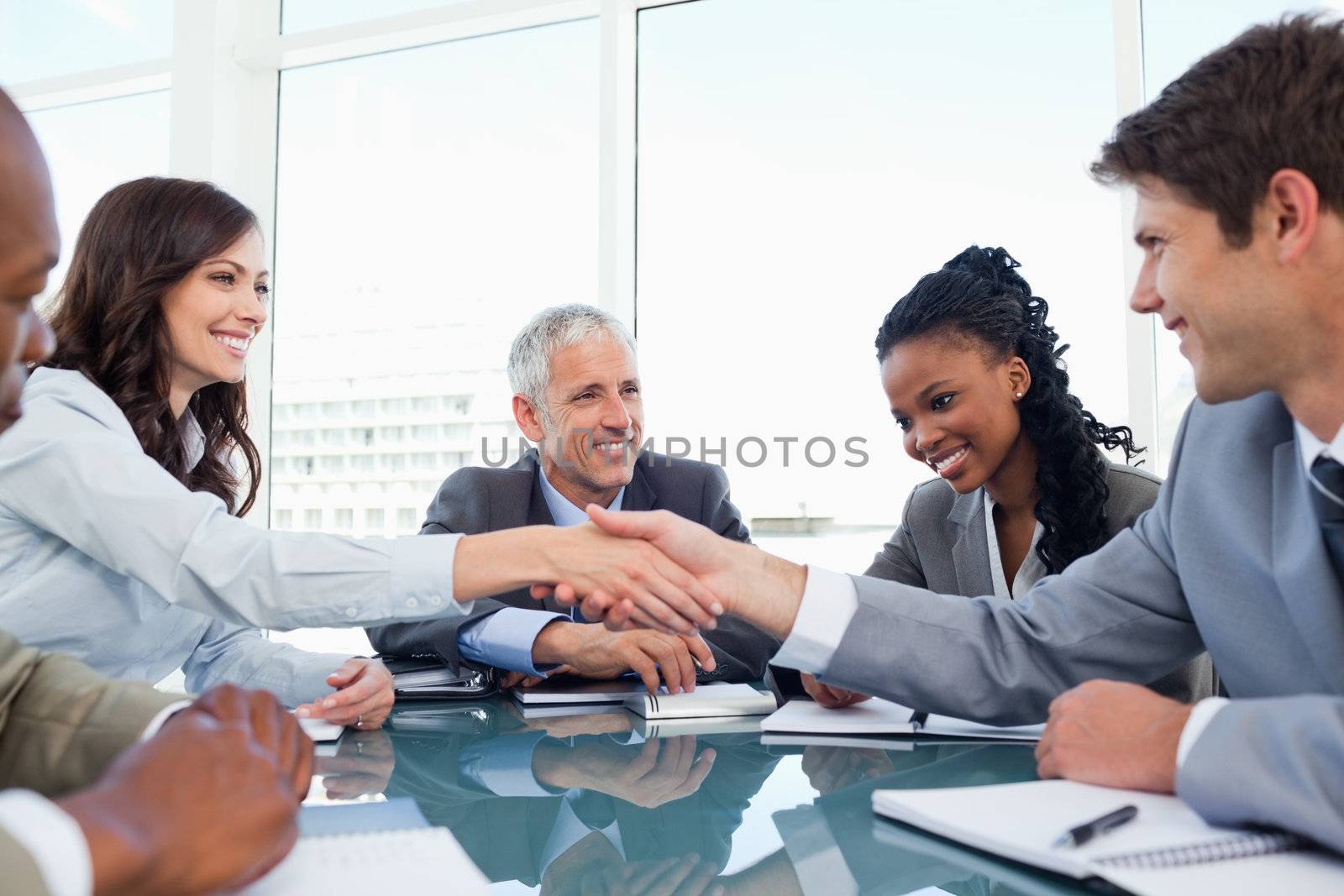 Handshake between a businesswoman and a co-worker when a meeting is ending