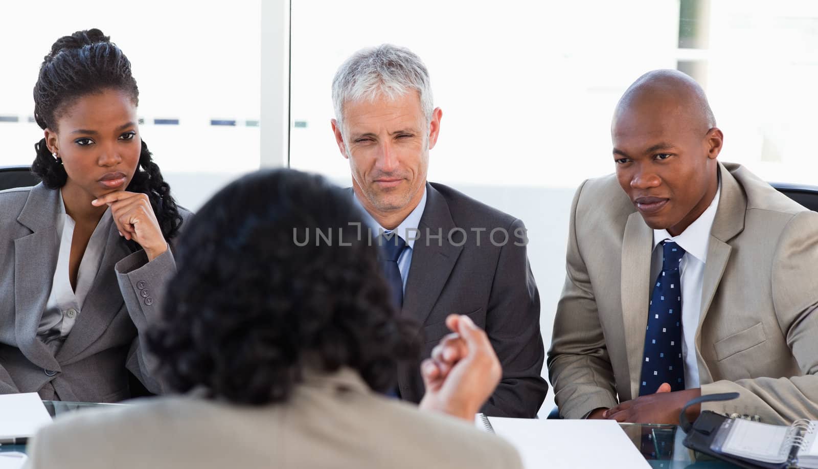 A business team is earnestly listening to an associate  by Wavebreakmedia