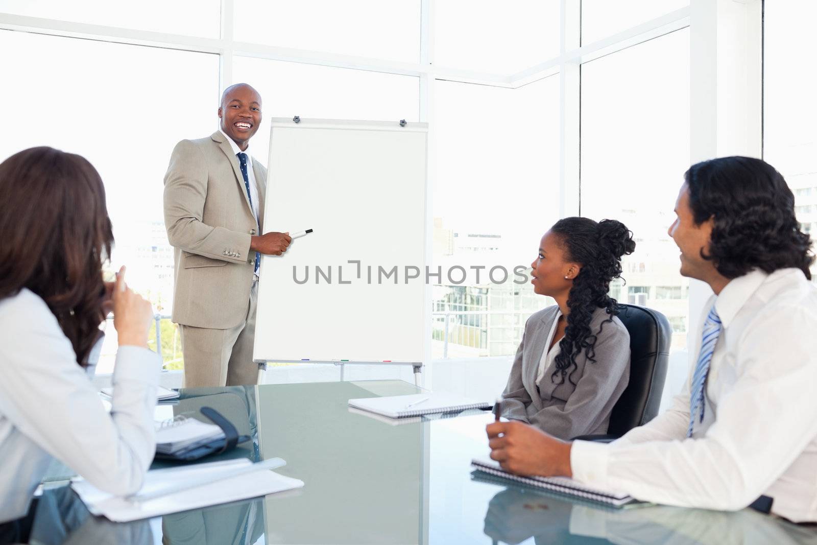 Smiling young businessman giving a presentation