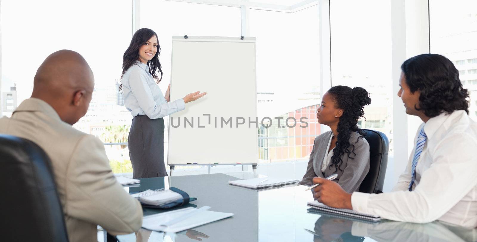 Three serious employees earnestly listening to a presentation