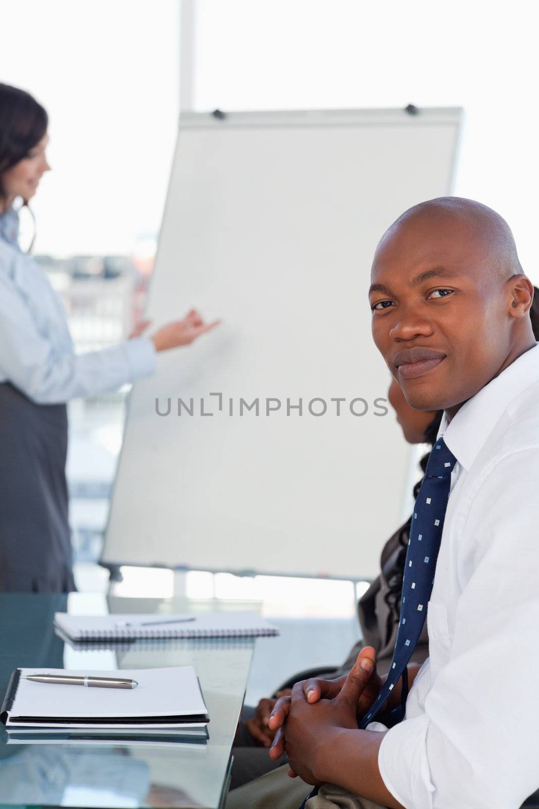 Businessman looking at the camera during a presentation given by by Wavebreakmedia