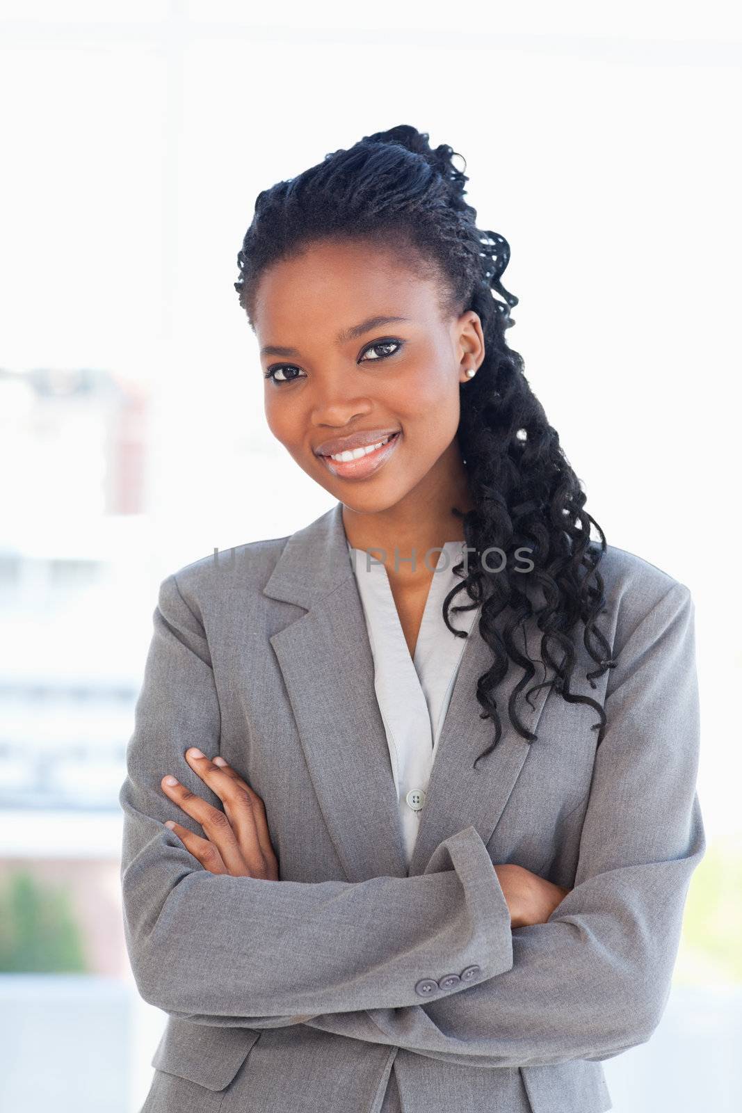 Employee crossing her arms while wearing a formal business suit by Wavebreakmedia