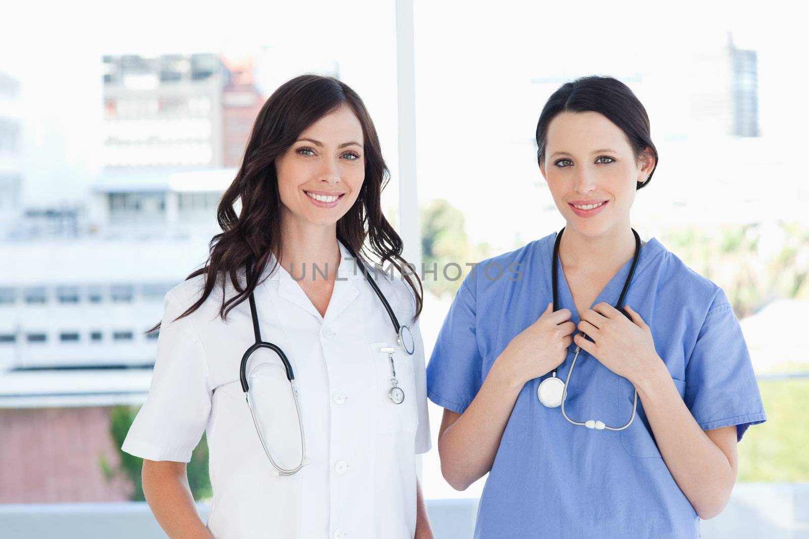 Medical interns standing upright in their short sleeve uniforms by Wavebreakmedia