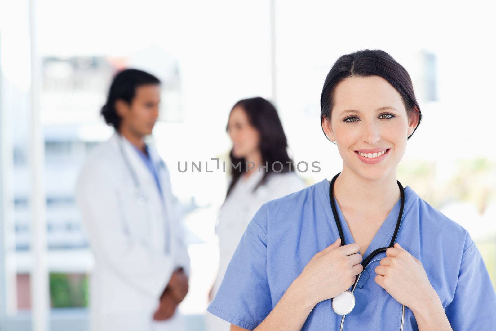 Confident intern standing in front of her medical team 