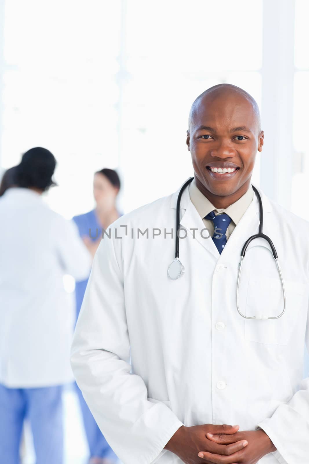 Young doctor wearing a tie under his white lab coat  by Wavebreakmedia