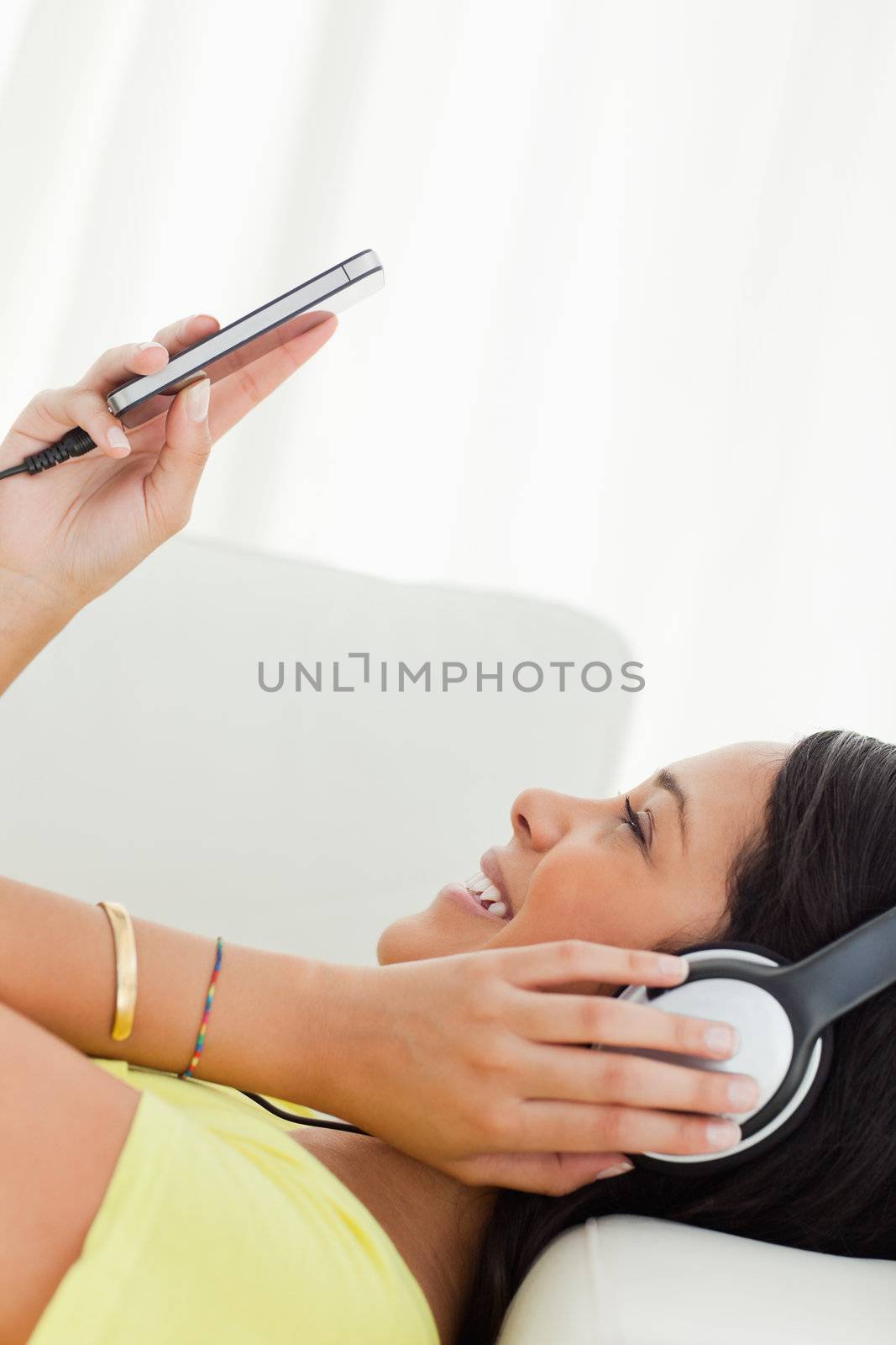 Close-up of a young Latino watching a video with earphones  by Wavebreakmedia