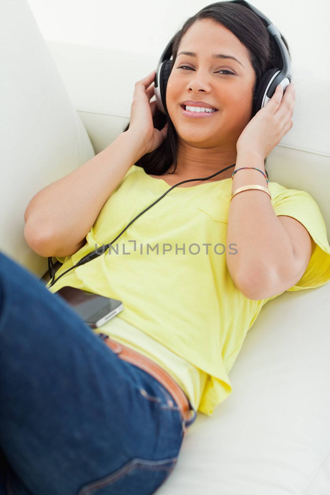 High-angle view of a young Latino listening music on a smartphon by Wavebreakmedia