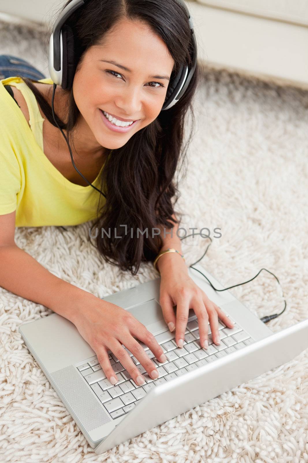 Portrait of a smiling Latin chatting on a laptop by Wavebreakmedia