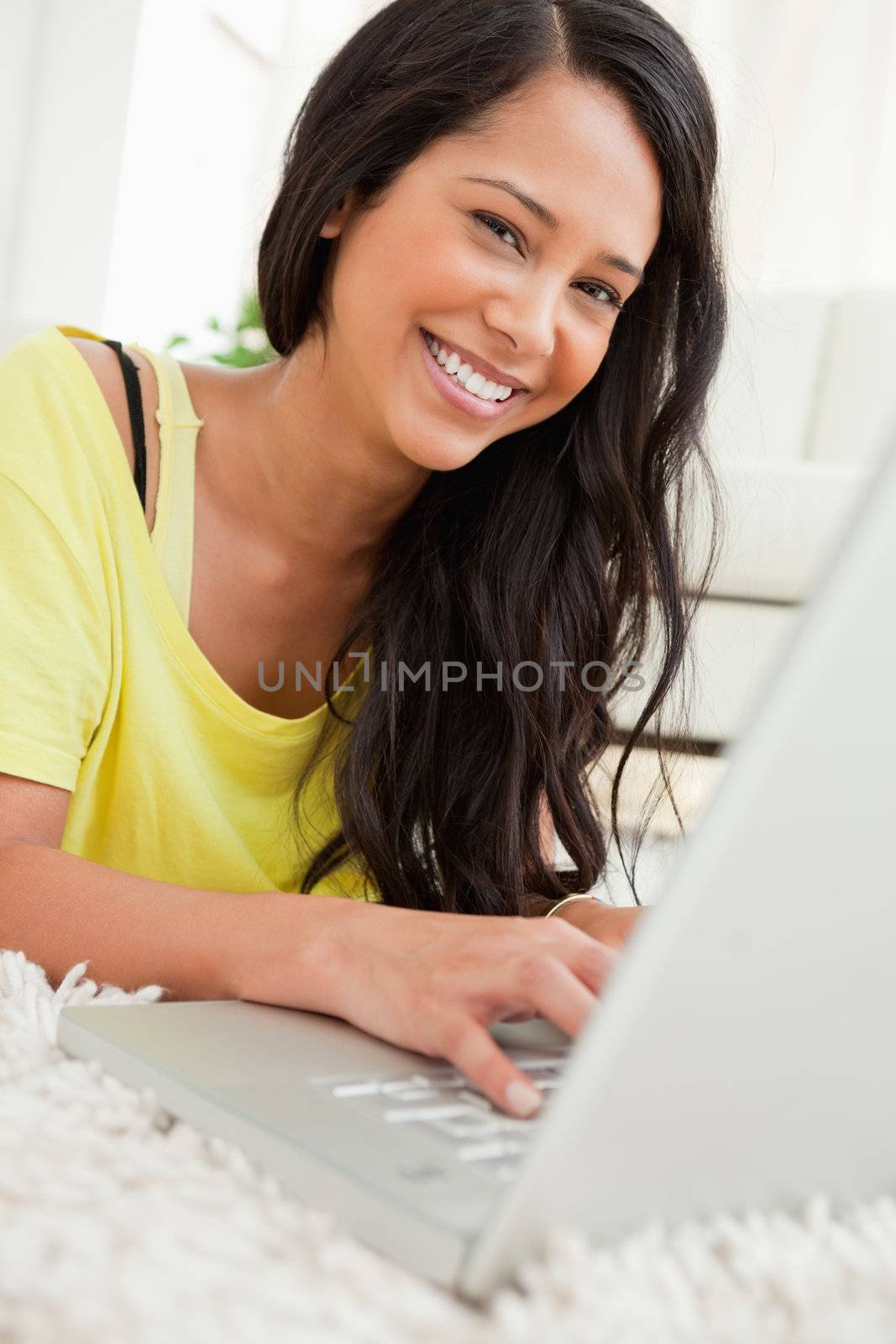 Portrait of a beaming Latin chatting on a laptop by Wavebreakmedia