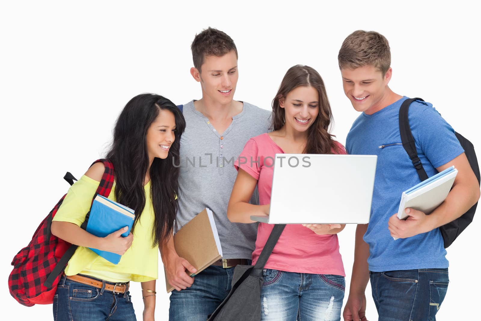 A smiling group of people looking into a laptop