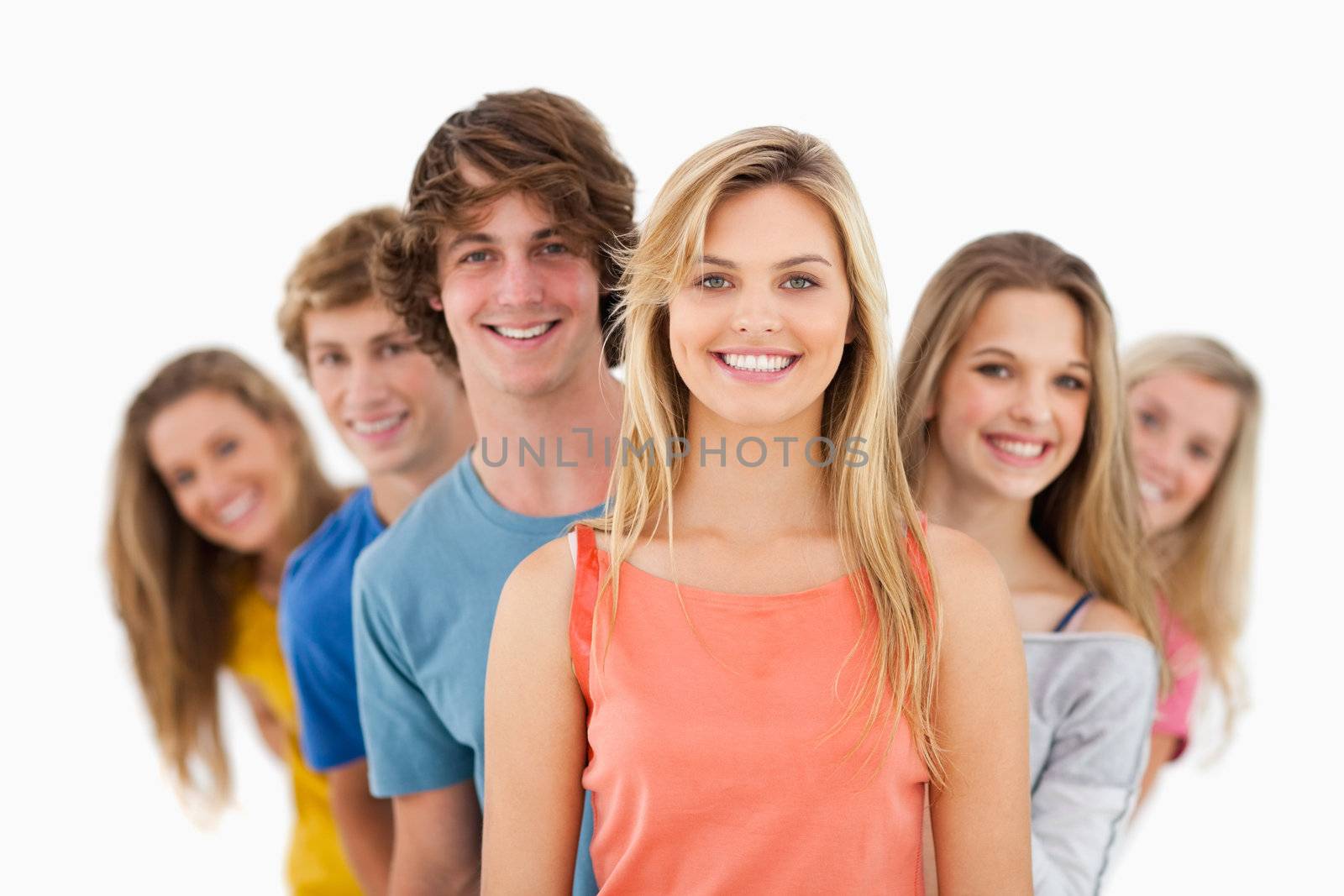 A smiling group standing behind one another at varied angles