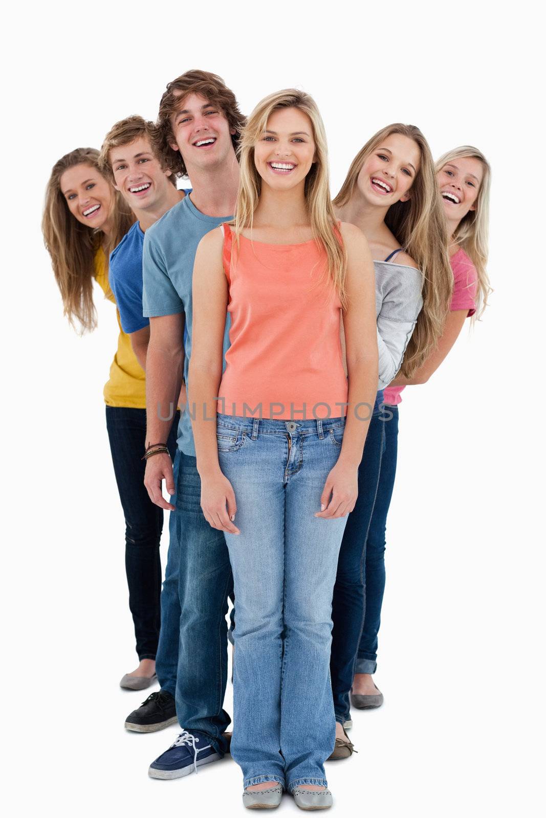 A smiling group of people standing and looking at the camera 