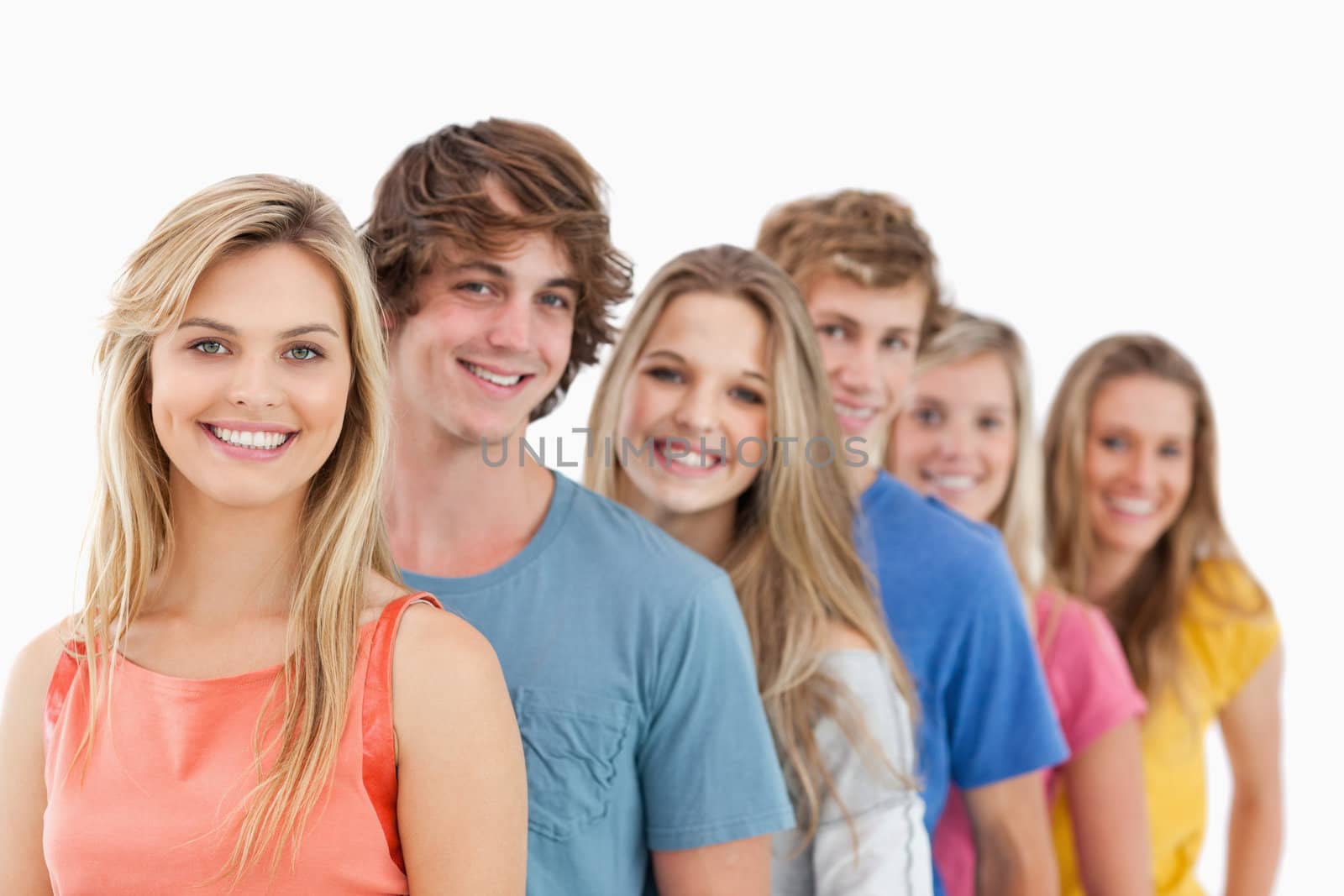 A group standing behind one another at an angle while looking at the camera