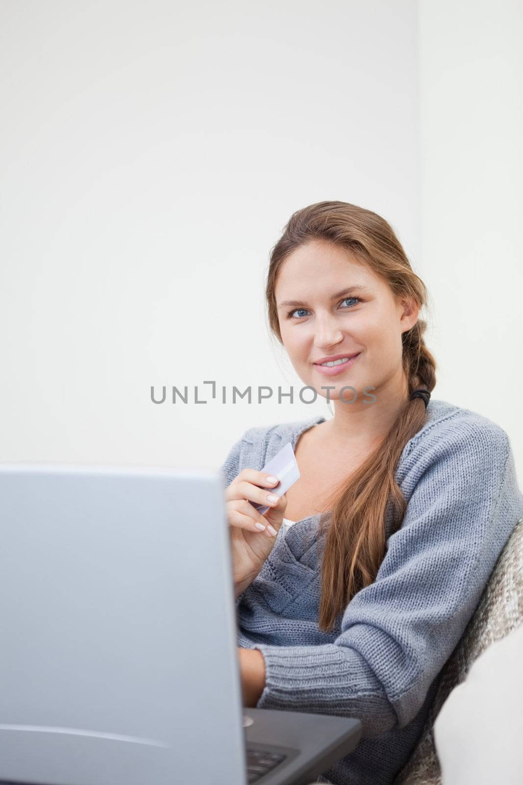 Woman sitting while using her tablet computer by Wavebreakmedia