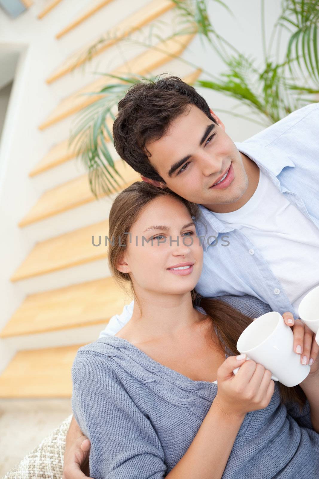 Young Couple smiling while embracing each other indoors