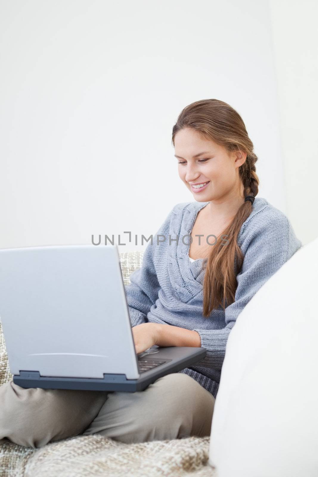 Women sitting while using a laptop in a sitting room