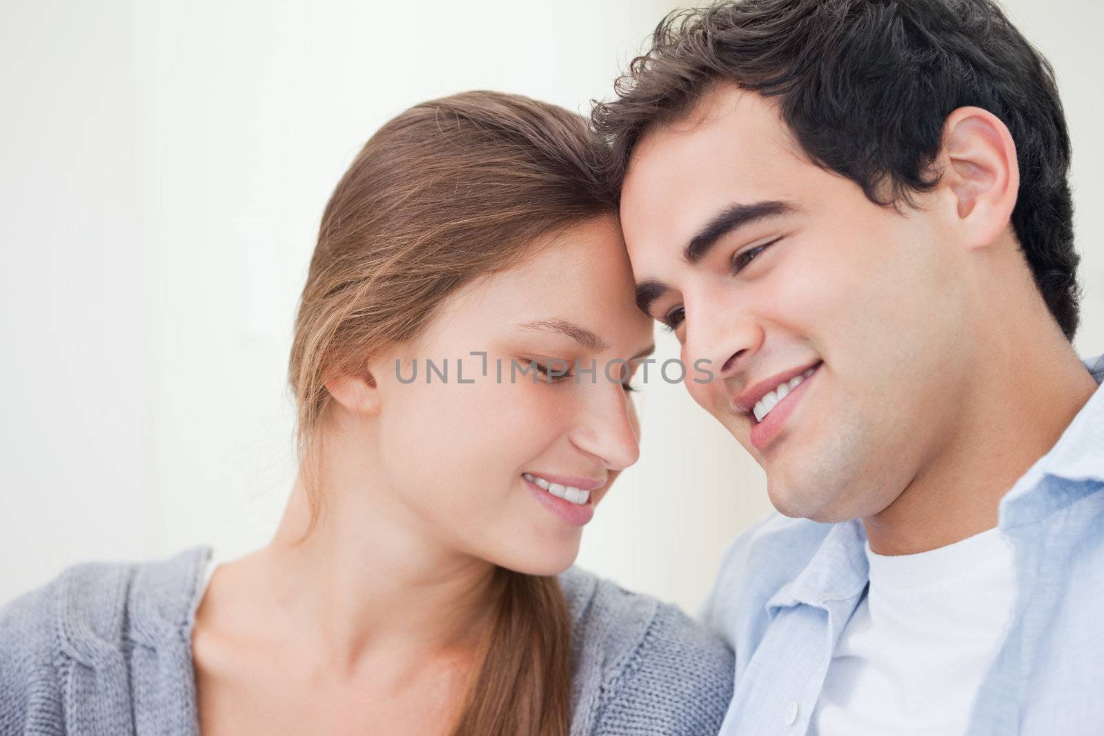 Young Couple embracing each other against a grey background 