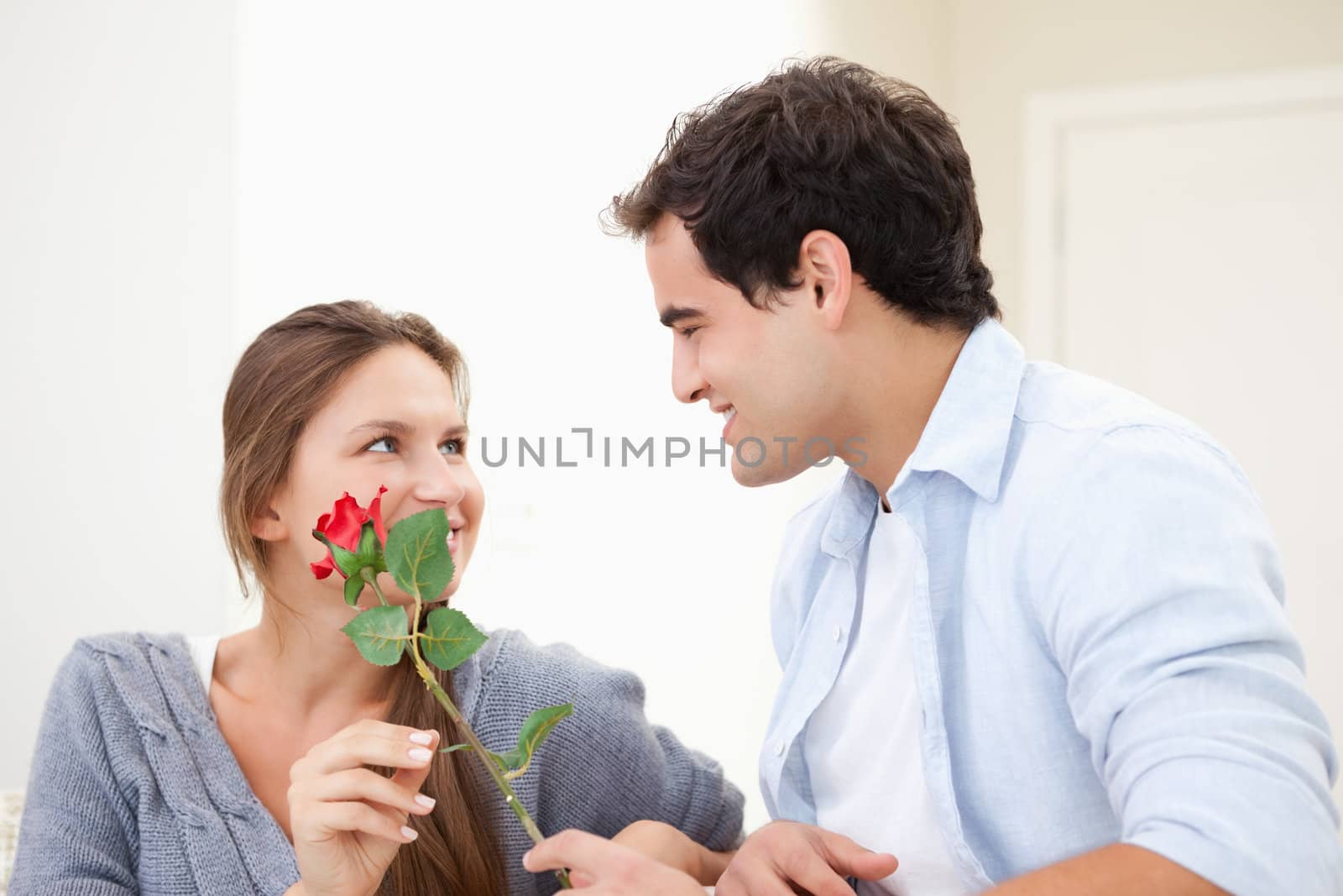 Man offering a rose to a Woman  by Wavebreakmedia