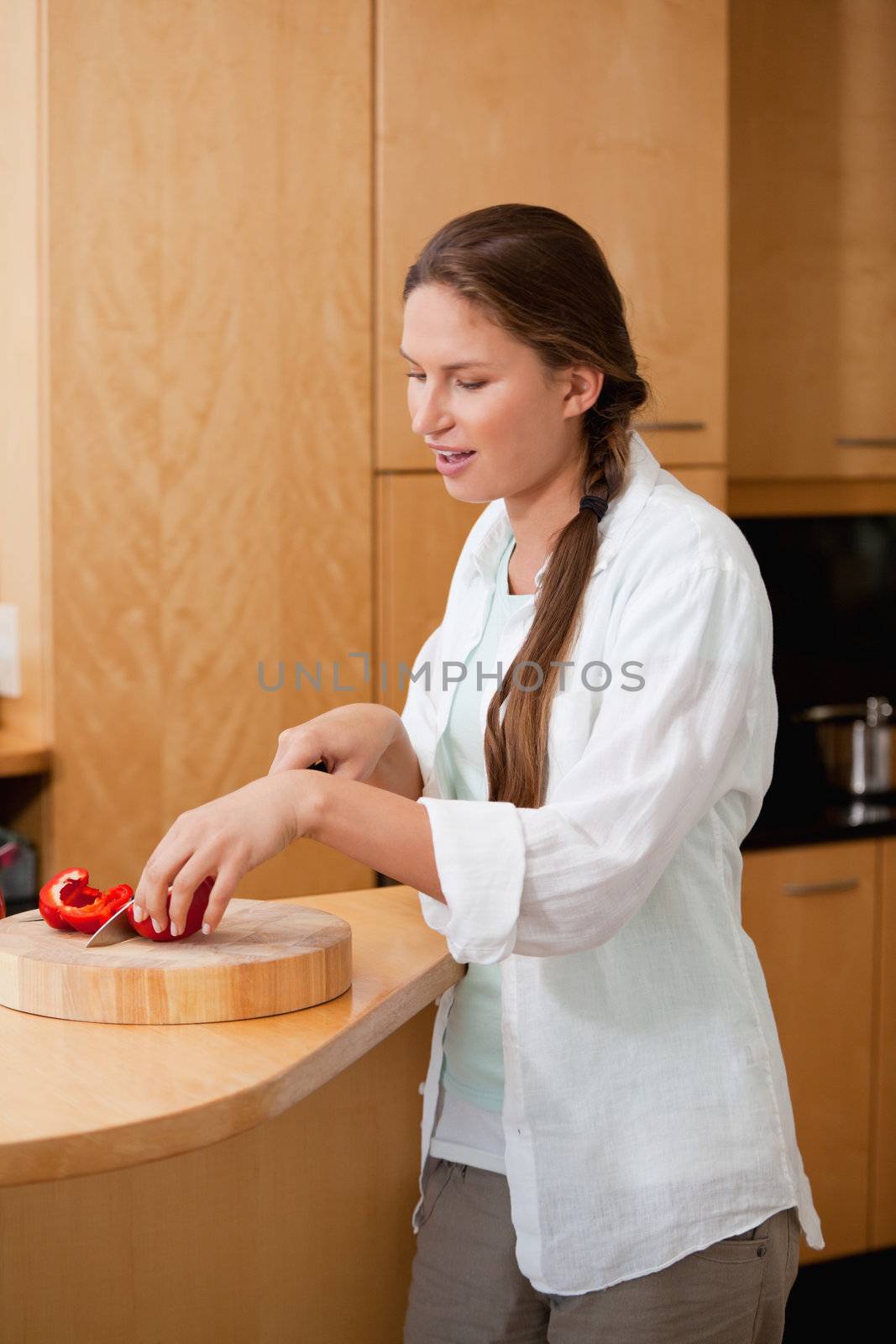 Woman cutting a pepper  by Wavebreakmedia