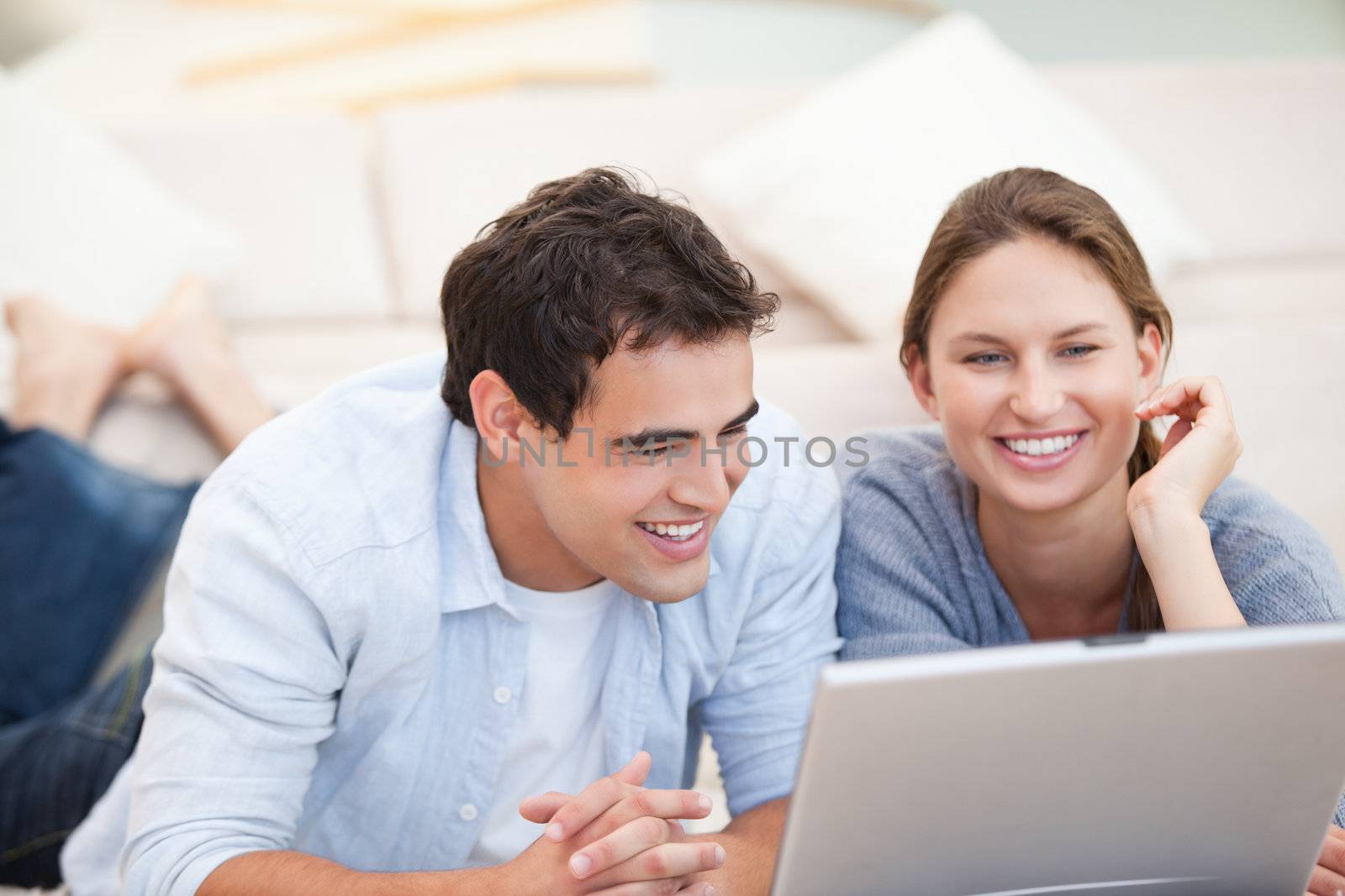 Young Couple watching a computer by Wavebreakmedia