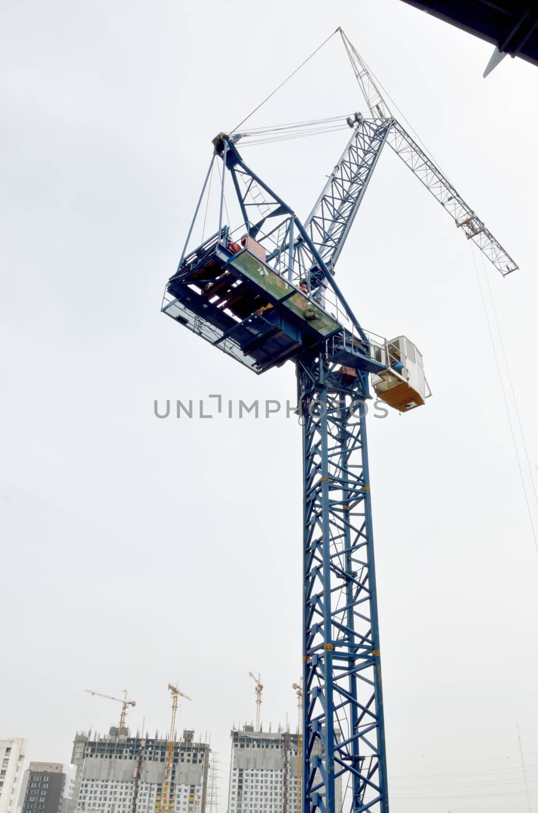 Crane tower working on site by pixbox77