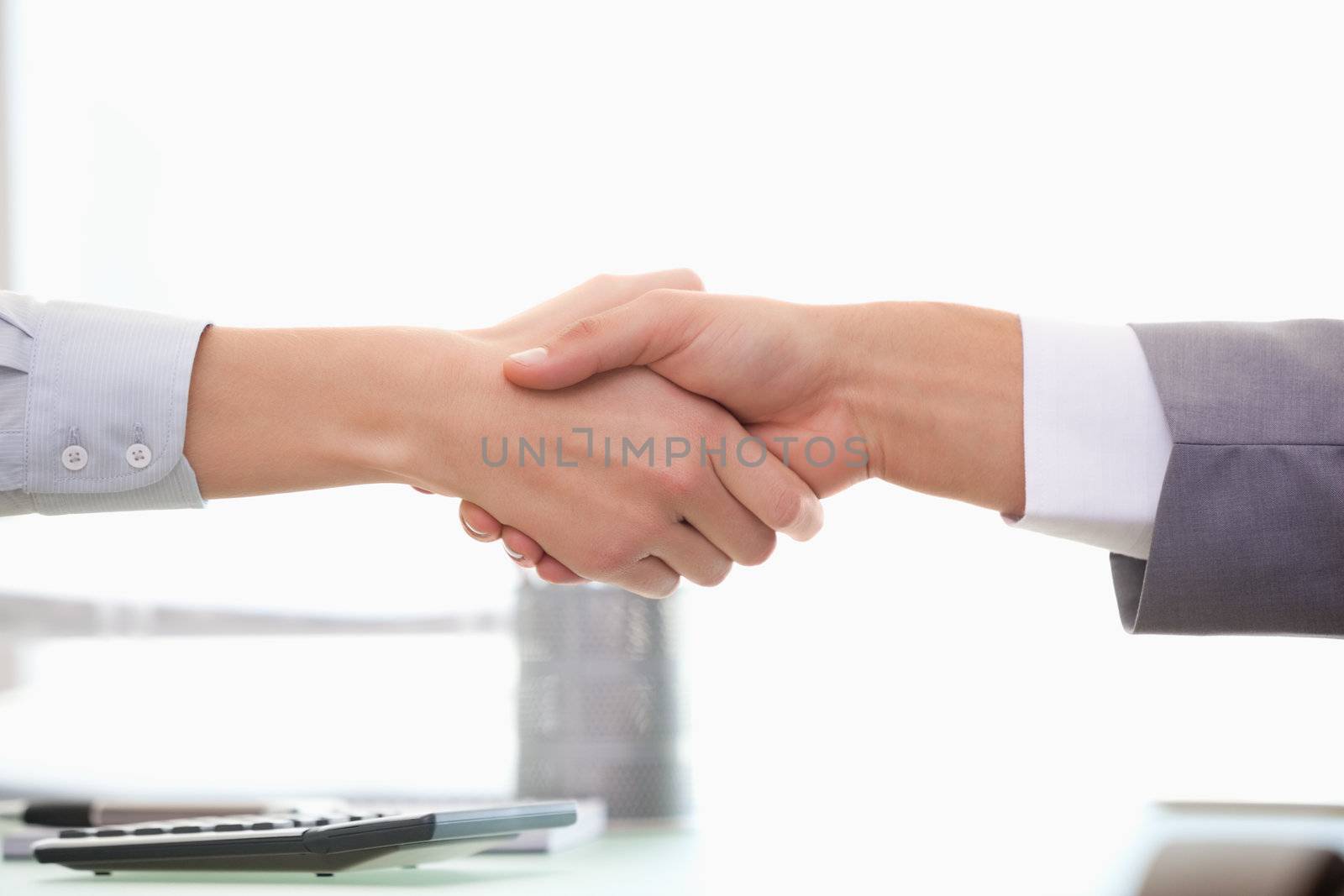 Man and Woman shaking hands in  an office