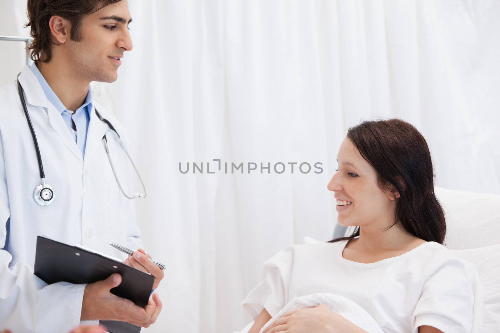 Patient smiling while talking to a doctor by Wavebreakmedia