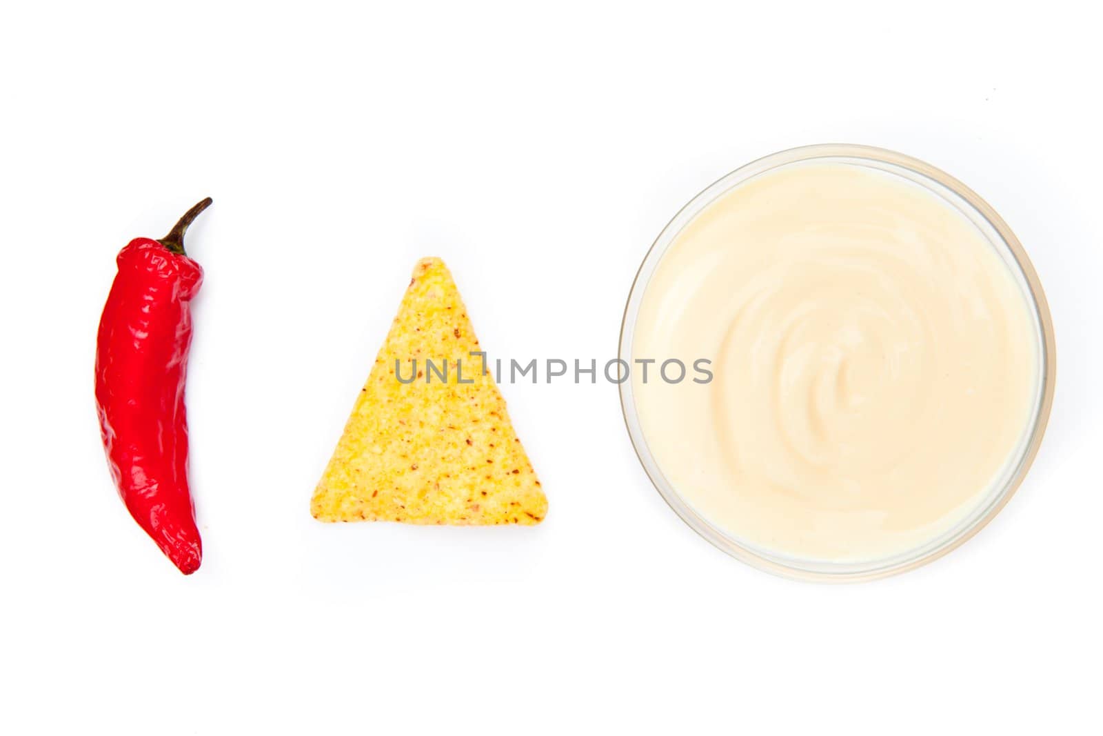 Bowl of dip nacho and pepper side by side against a white background